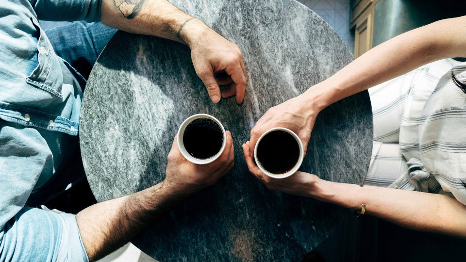 couple holding coffee mugs swarm