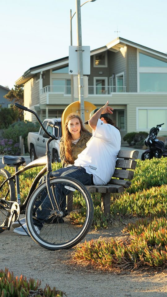 couple sitting on park bench swarm